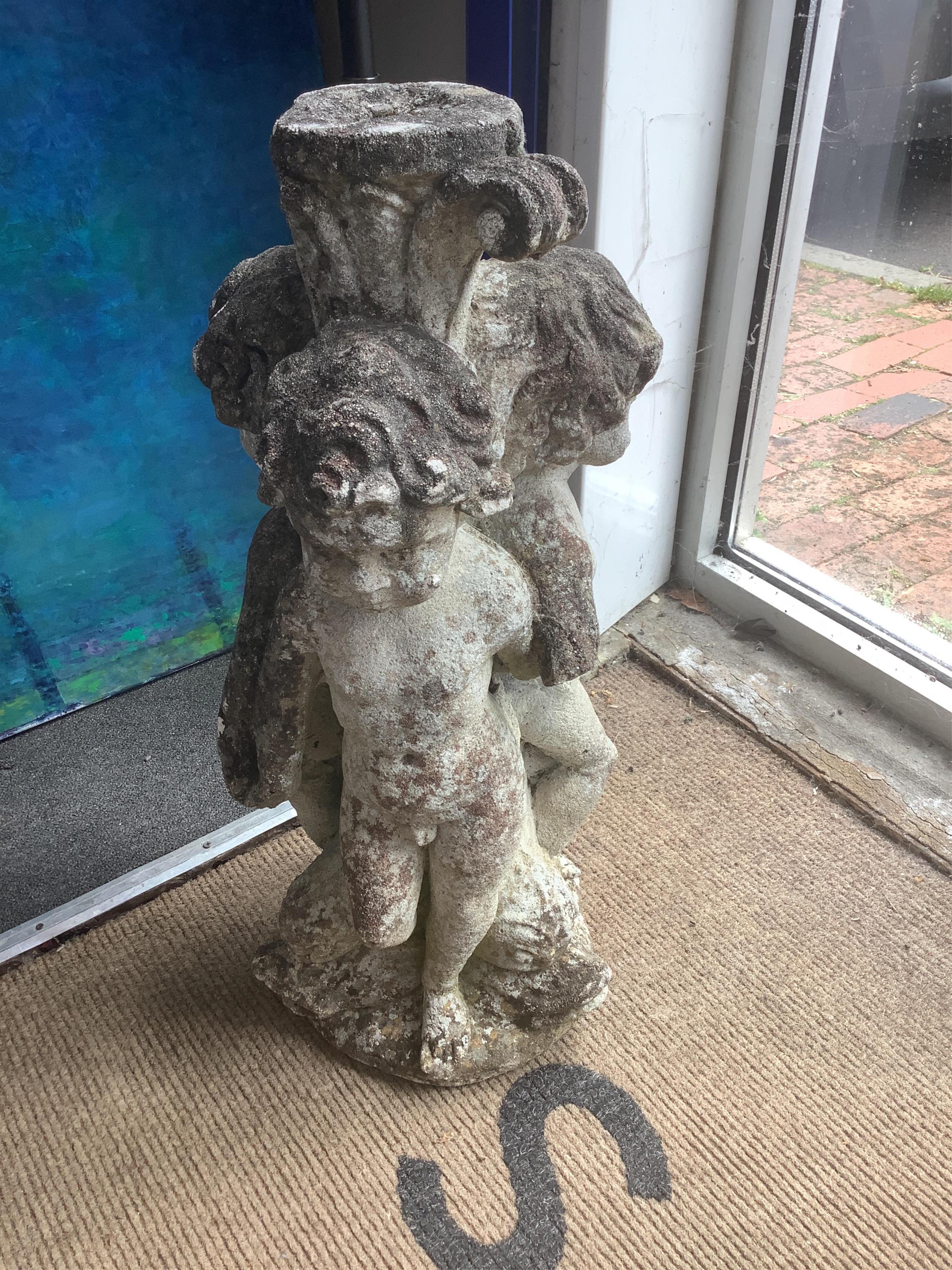 A pair of reconstituted stone triple cherub garden ornaments, height 70cm. Condition - fair